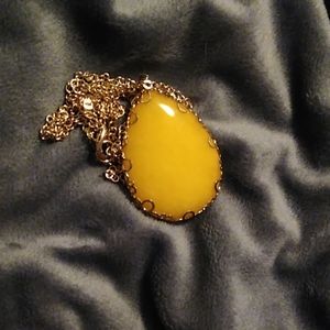 Long gold necklace with yellow pendent